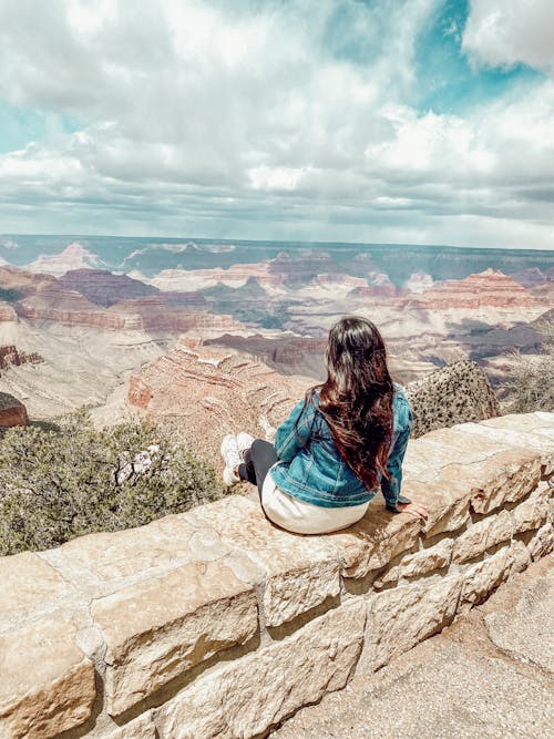 Free Woman in Denim Jacket Looking at a Scenic View Stock Photo