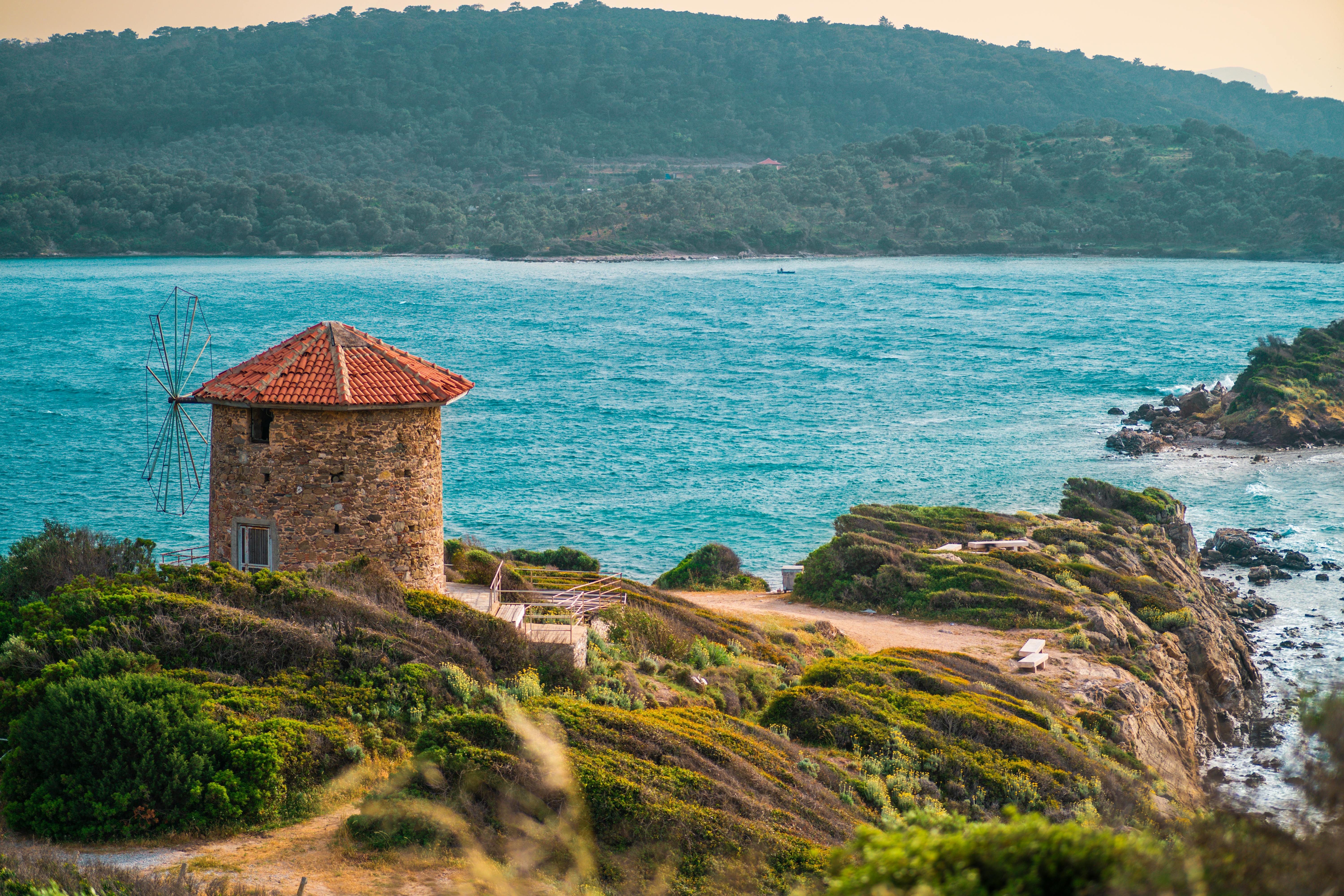 Beautiful windmill on a cliff in Bodrum, Turkey with stunning seaside views.