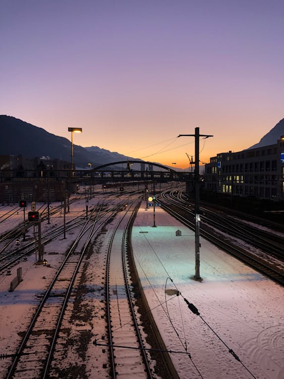 An Aerial Photography of a Snow Covered Ground Near the Train Tracks