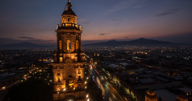 Aerial view of Morelia Cathedral glowing against the night sky in Mexico.