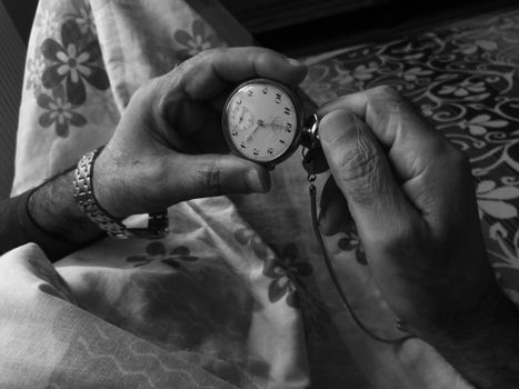 Person Holding Silver Round Analog Watch