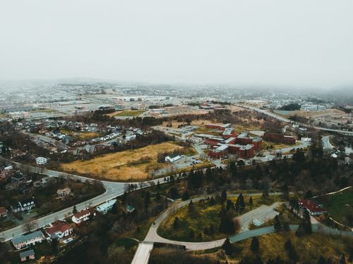 Free Aerial photograph showcasing a foggy urban landscape with roads and buildings. Stock Photo