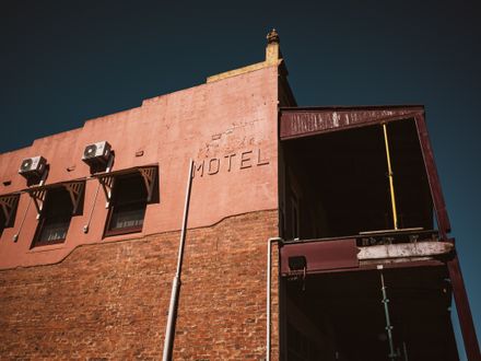 A weathered roadside motel building at dusk — Sonny Sixteen on Pexels