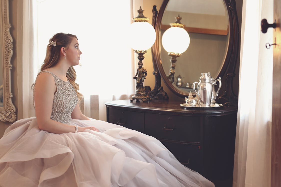 Free Woman Wearing Gown Looking at Mirror Stock Photo
