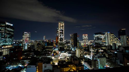 Free Illuminated skyscrapers and vibrant cityscape of Mexico City at night showcasing its urban beauty. Stock Photo