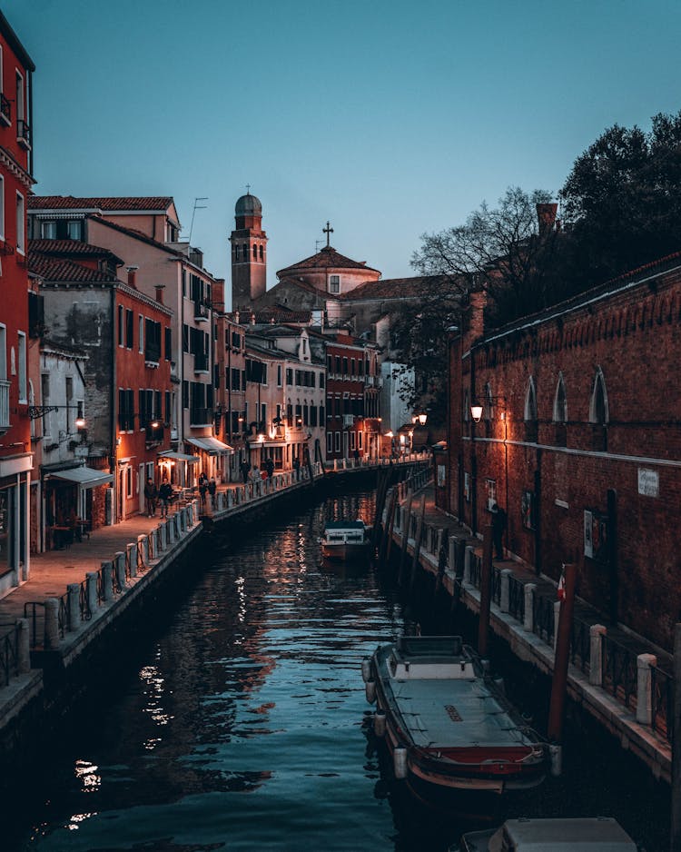 Illuminated Street Beside The Water Canal During Night Time