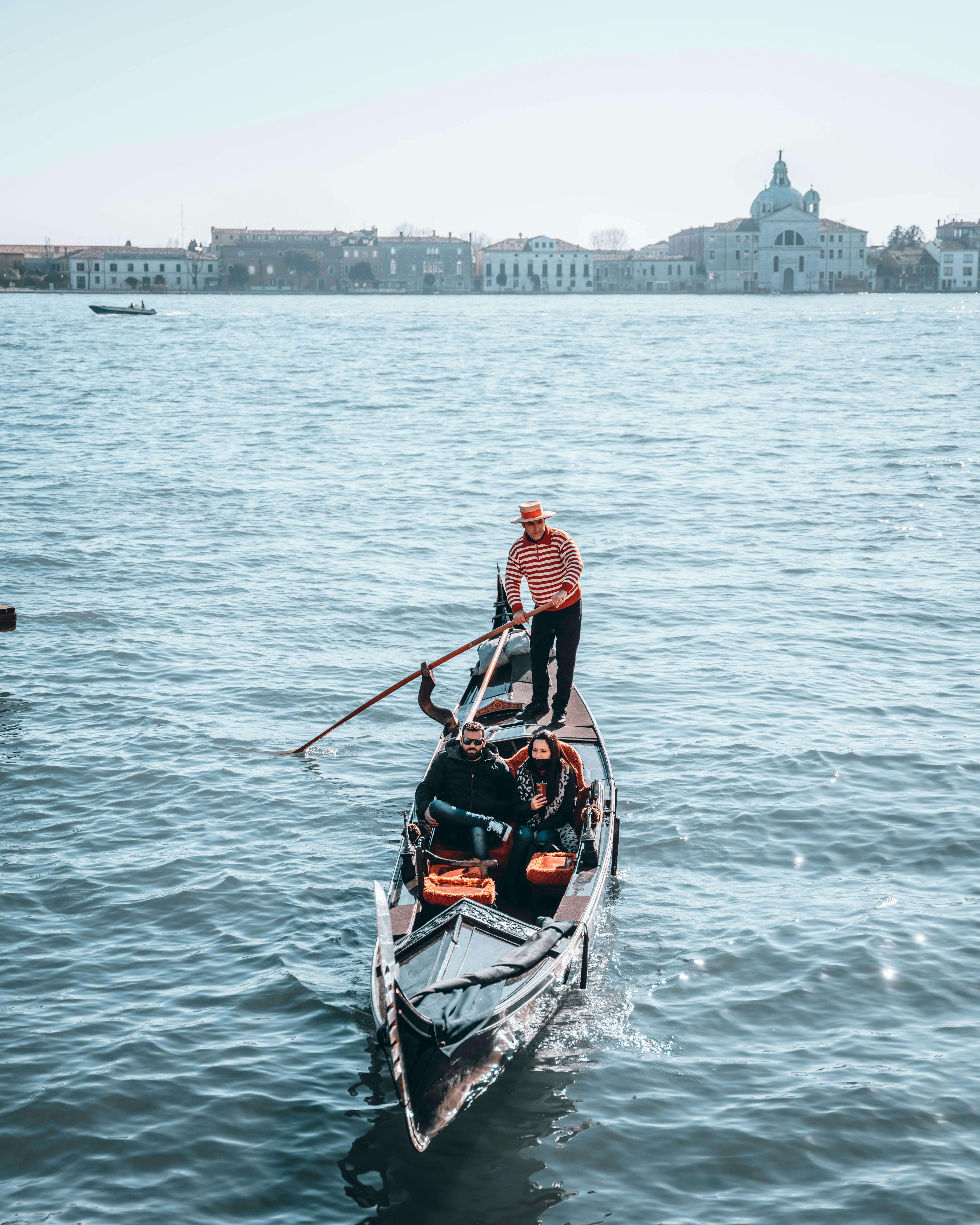 A peaceful gondola ride with tourists on Venice's Grand Canal, Italy.