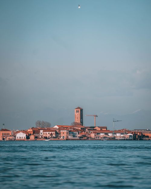 Free A scenic panorama of Venice featuring Sant Elena Church with clear blue skies and tranquil waters. Stock Photo