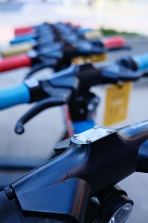 Free Close-up view of a lined row of rental scooters in Poznań, Poland, showcasing urban mobility. Stock Photo