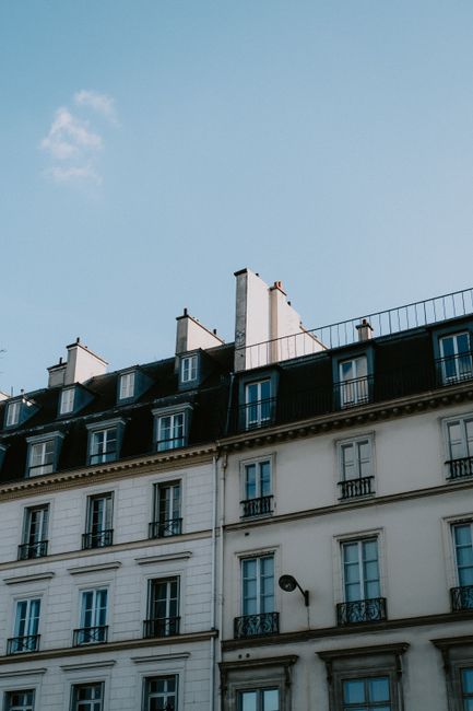 Elegant urban townhouse exterior against a clear sky, ideal for real estate and architecture themes.