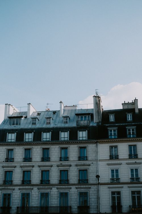 Free A beautiful image of classic European townhouses set against a clear blue sky. Stock Photo