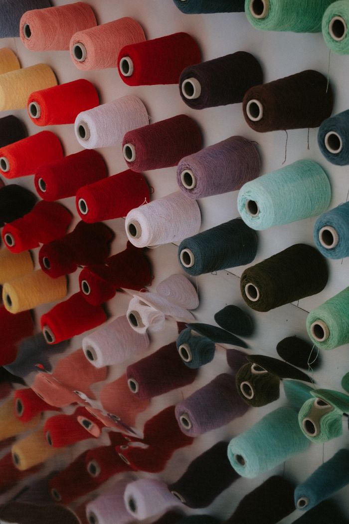 Rows of yarn spools arranged on display