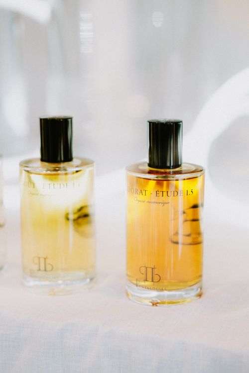 Free Two stylish glass perfume bottles with black caps on a bright background. Stock Photo