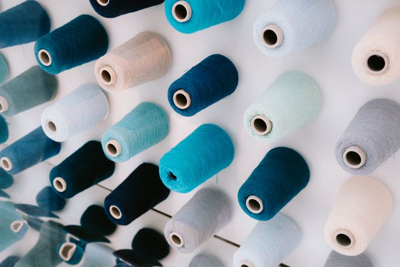 Colourful embroidery thread spools arranged in a pattern