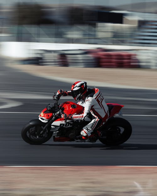 Motorcycle Rider on Ducati Racing on Circuit