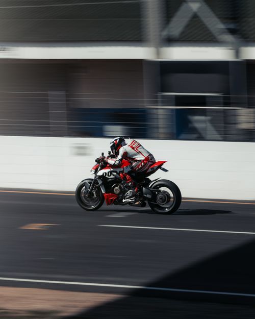 Free High-speed action shot of a motorbike racer speeding on a track. Adrenaline and precision. Stock Photo