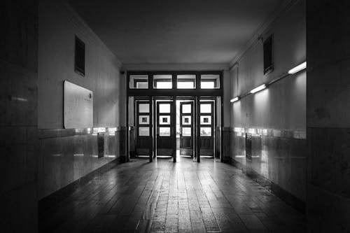 Grayscale Photo of a Corridor