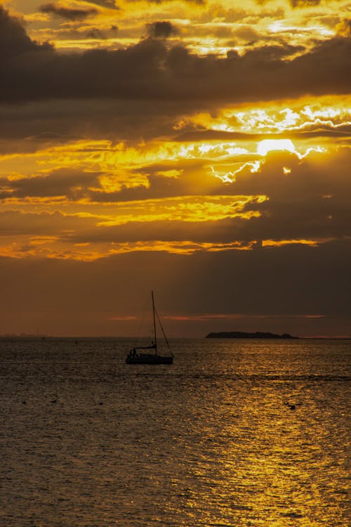 Silhouetted Sailboat on the Sea at Sunset 