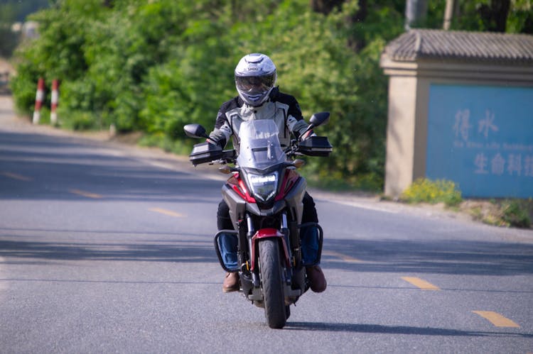 Man Riding Motorcycle On Road