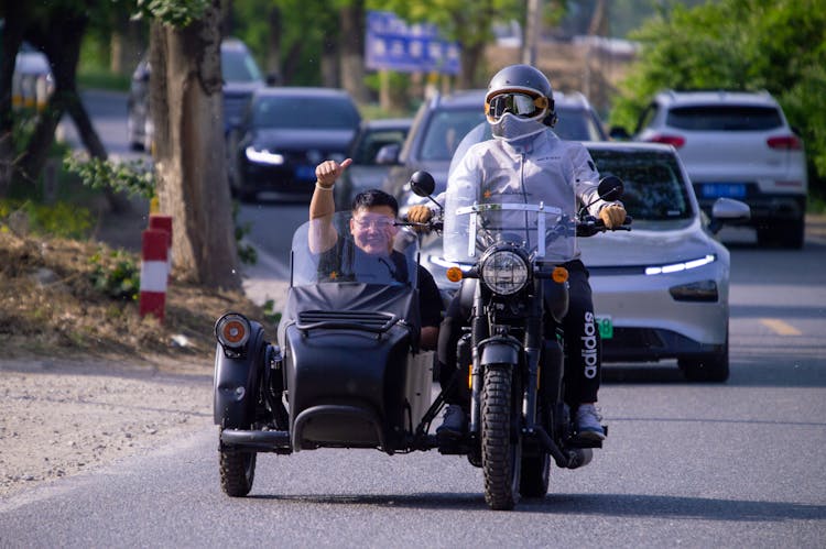 A Motorcycle With A Sidecar On A Road