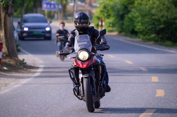 Man Riding Motorcycle On Road