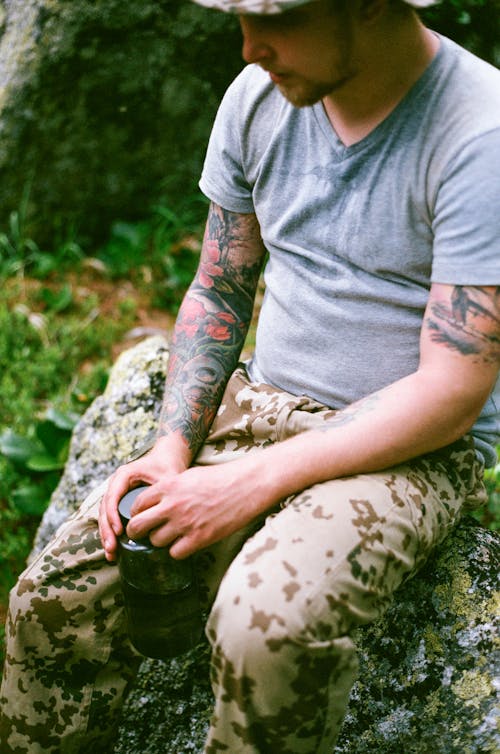 Man in Gray Shirt Holding a Tumbler