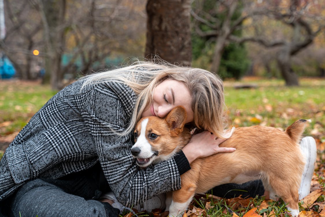 A Woman Hugging Her Dog 