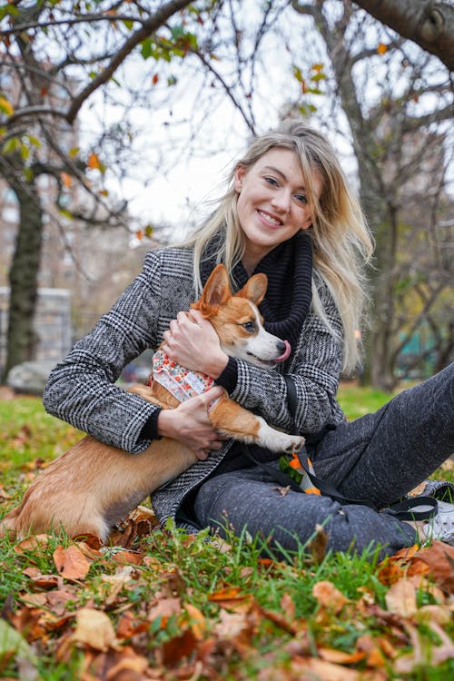 Woman Sitting on the Ground with a Dog