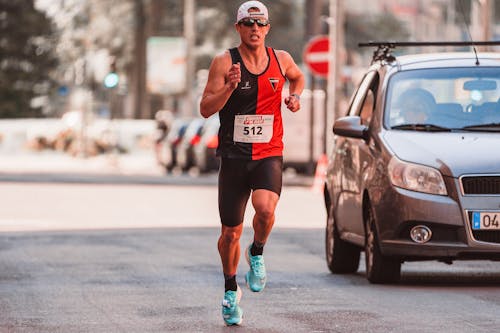 Photo of a Man Running in a Race