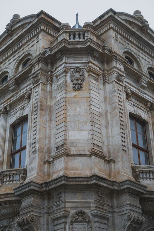 Free Detailed view of a historic baroque building facade showcasing intricate stonework and classic architecture. Stock Photo