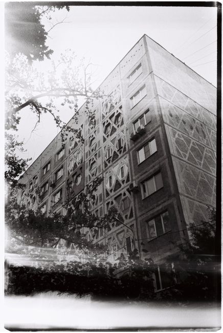 Beautiful black and white photograph of a detailed apartment building facade in Almaty, Kazakhstan.