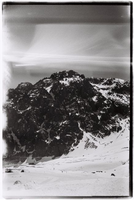 Explore the rugged snow-capped mountains of Almaty, captured in stunning black and white.