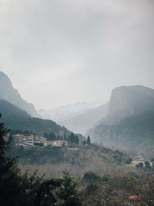 Free Serene foggy view of mountain village nestled in Thessaloniki, Greece. Stock Photo