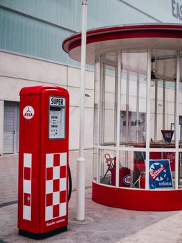 A retro-style red gas pump with vintage design details in Frankfurt am Main.