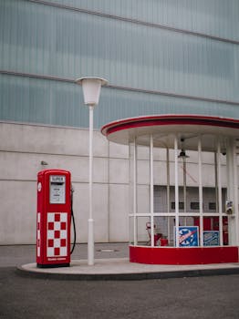 Retro petrol station in Frankfurt with vintage style red pumps and classic architecture.