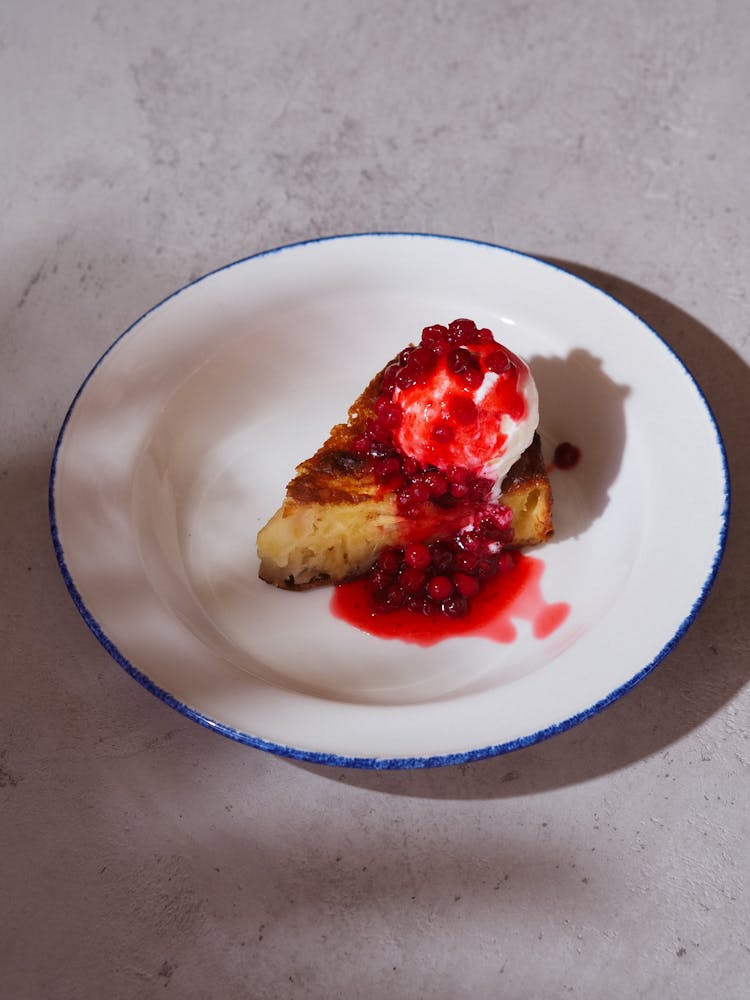 Slice Of Pie With Cream And Toppings On A Ceramic Plate