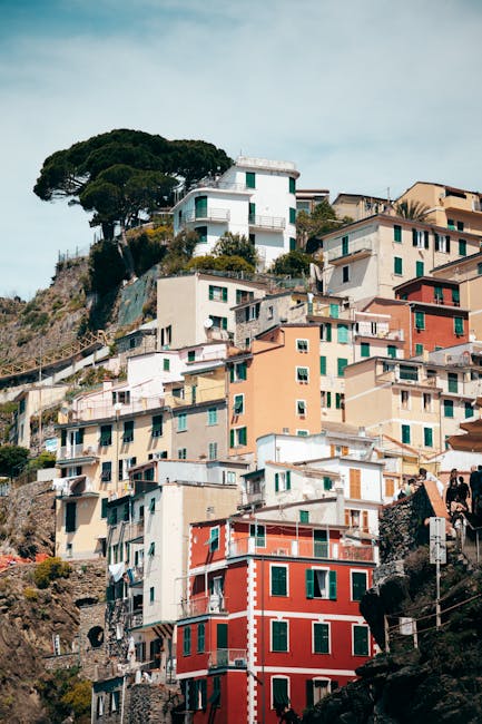 Picturesque view of vibrant houses stacked on a hill in Riomaggiore, Liguria, Italy.
