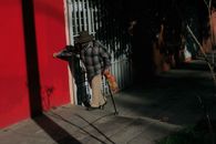 An Elderly Man Walking on the Street
