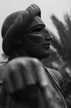 A black and white photo capturing the intricate details of a carved statue's profile.