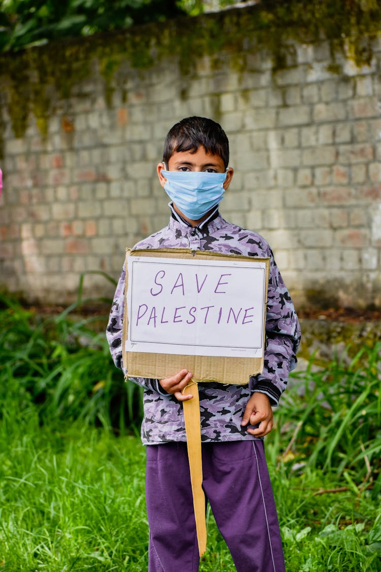 Boy Holding A Sign