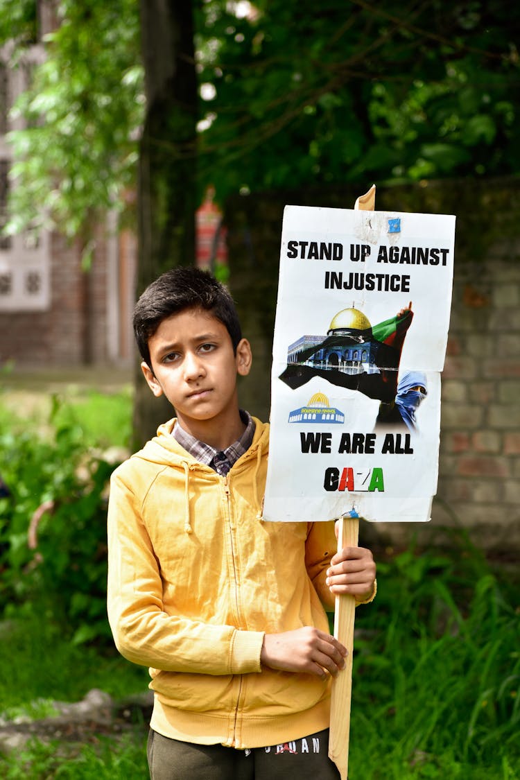 Boy Holding Political Placard About Gaza