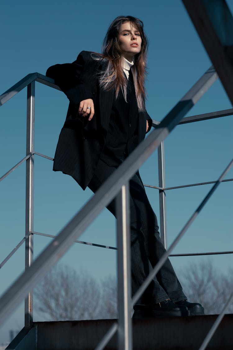 Woman Posing On Metal Stairs