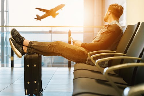 Free Man in airport waiting for boarding on plane Stock Photo