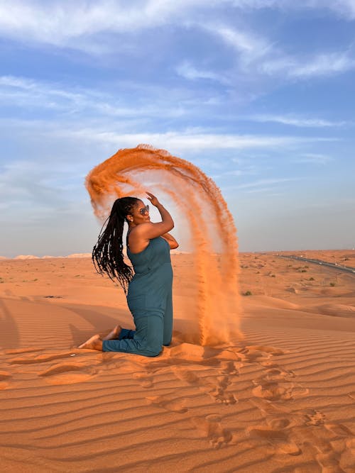 Brunette in Onesie Posing at Sandy Desert