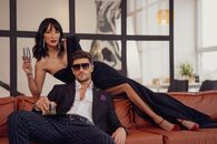 Elegant Dressed Couple Posing for Photograph on Sofa