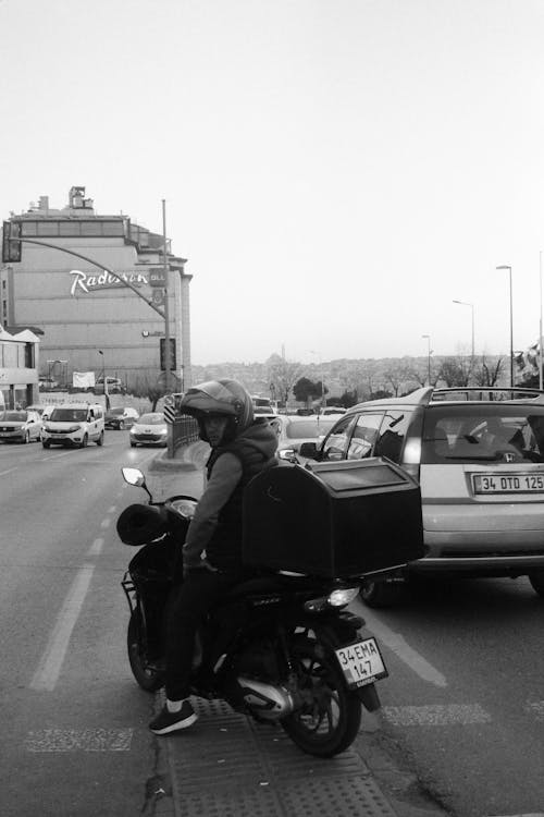 Man on a Scooter on a City Street