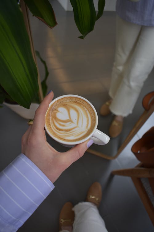 A Person Holding a Cup of Coffee