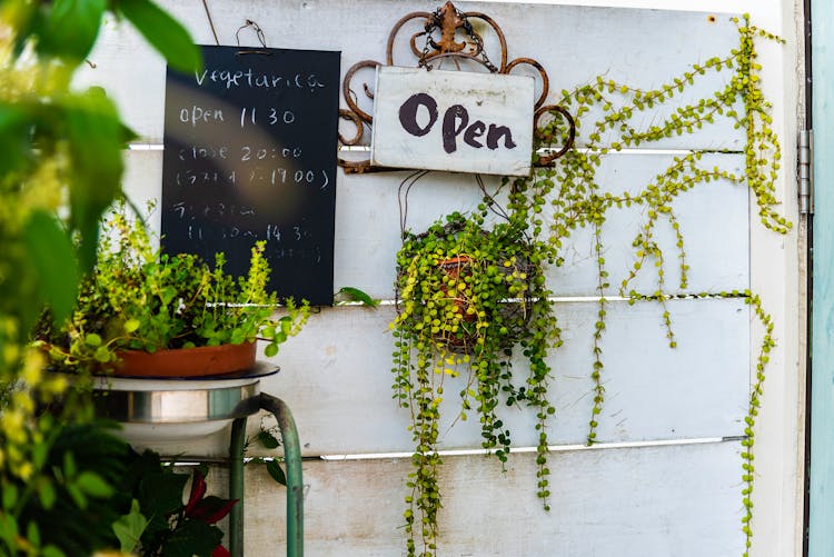 Open Signage Mounted On White Wall