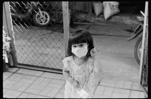 Black and White Photo of Kid Wearing a Face Mask