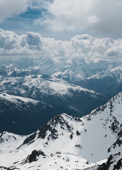 Free Snow Covered Mountains Under White Clouds Stock Photo